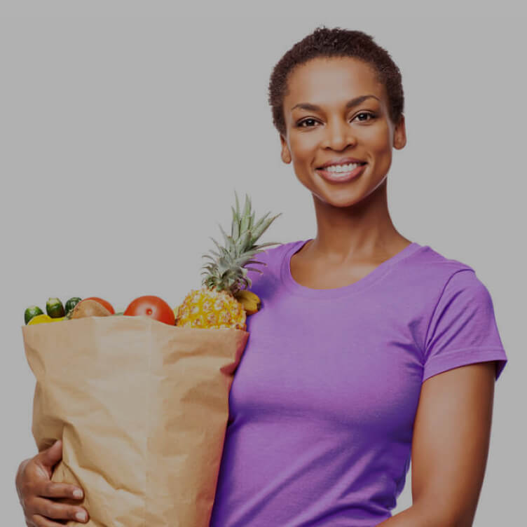 Woman carrying a bag of groceries