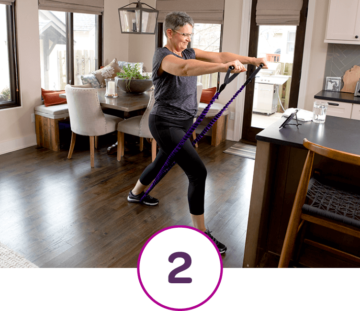 Woman in Living Room Using Resistance Band and #2 in Circle