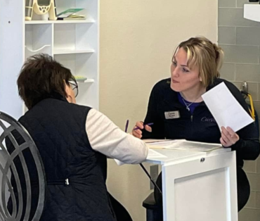 Curves employee and customer sitting at a desk