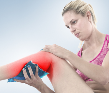Woman using ice pack on her calve