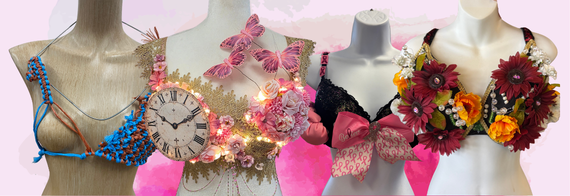 A horizontal banner graphic for the Curves Bra Decorating Competition for breast cancer awareness, featuring a lineup of four stylized mannequin torsos against a soft pink abstract backdrop. From left to right, the designs showcase a rustic blue and orange braided twine construction, an ornate gold lace theme adorned with a vintage Roman numeral clock face and pink butterflies lit by fairy string lights, a black lace foundation finished with a large pink bow patterned with awareness ribbons, and a dark floral design densely packed with realistic deep red sunflowers and orange blooms.
