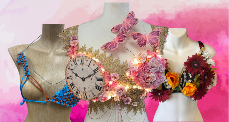A horizontal banner graphic for the Curves Bra Decorating Competition for breast cancer awareness, showcasing a close-up arrangement of three creative mannequin displays layered against a vibrant pink-and-purple watercolor background. The center mannequin takes prominence, highlighting a gold lace garment beautifully framed by cascading pink fabric flowers, small glowing warm lights, a classic round clock face, and three delicate pink monarch butterflies hovering on fine wires above the chest, flanked by the rustic braided twine entry on the left and a dense autumnal sunflower design on the right.
